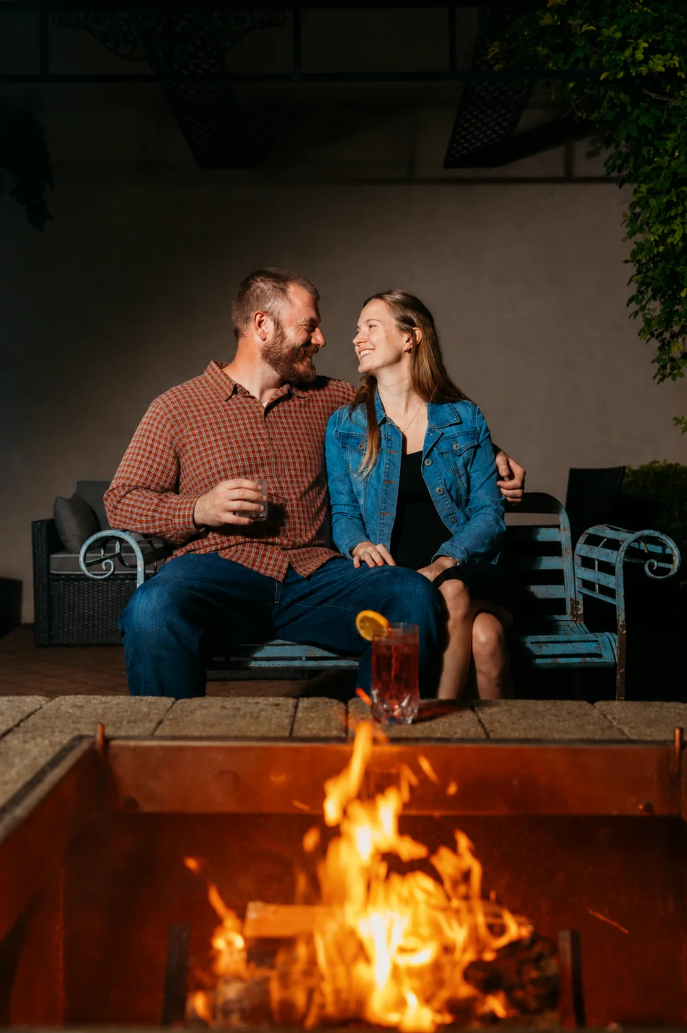 A couple by the courtyard fire pit at night